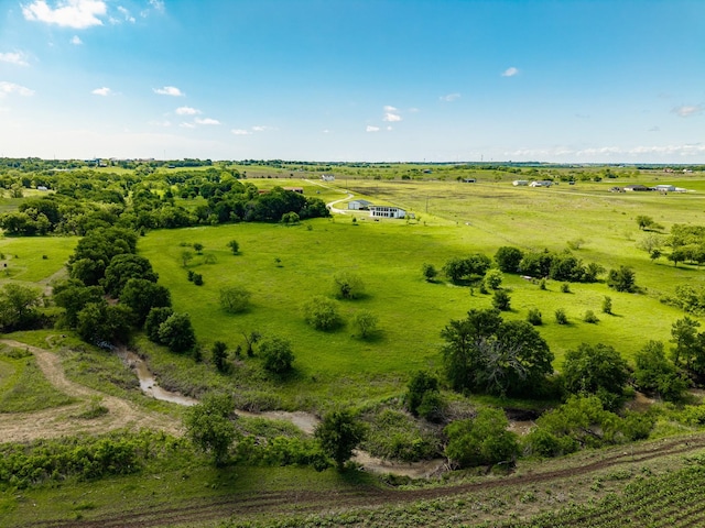 birds eye view of property with a rural view