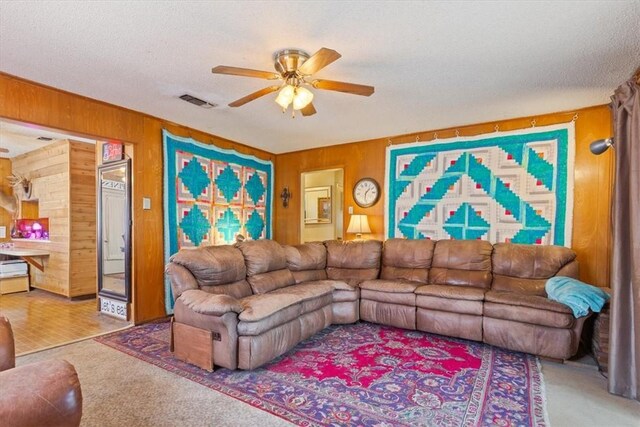 411 Brookwood Dr, Woodway, TX 76712 - carpeted living area with ceiling fan, wooden walls, and a textured ceiling