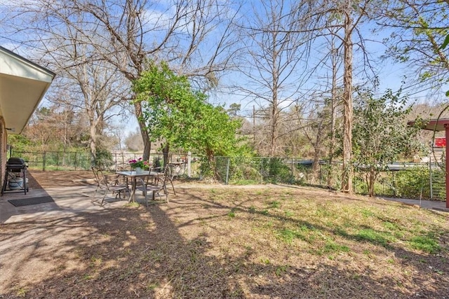 view of yard with a fenced backyard and outdoor dining area