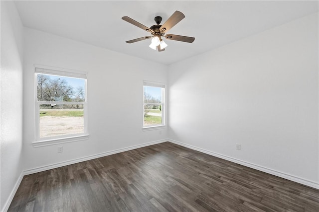 unfurnished room with dark wood finished floors, baseboards, and ceiling fan
