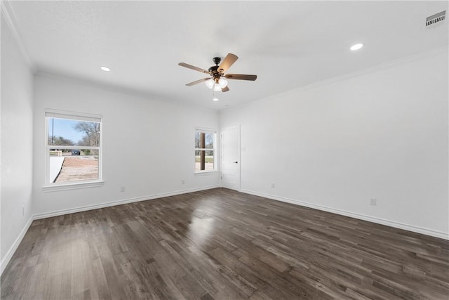 empty room featuring visible vents, a ceiling fan, dark wood-style floors, crown molding, and baseboards