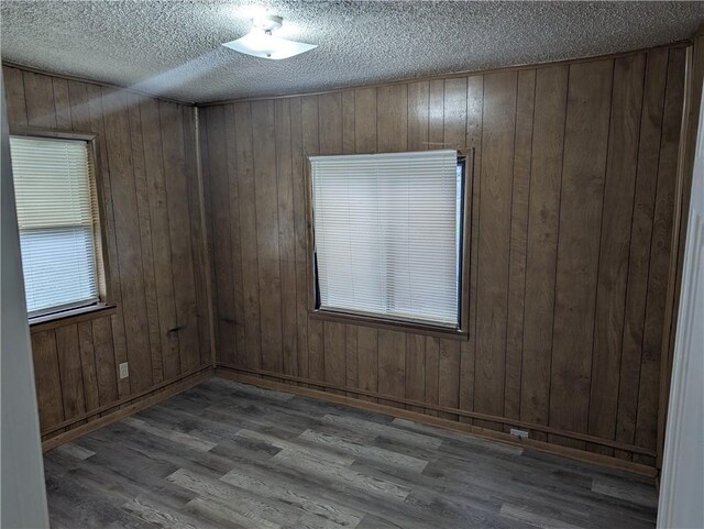 empty room featuring wood finished floors and a textured ceiling