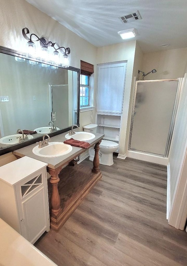 bathroom featuring a sink, visible vents, and a shower stall