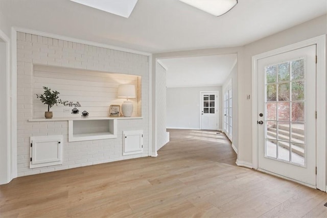 interior space featuring baseboards and light wood-style flooring