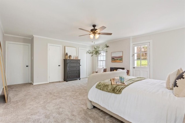 bedroom featuring baseboards, carpet floors, ornamental molding, and a ceiling fan