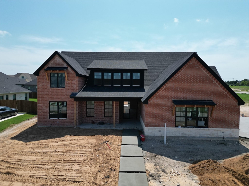 14000 Rw Ct, Woodway, TX 76712 - view of front of home featuring brick siding, roof with shingles, and covered porch