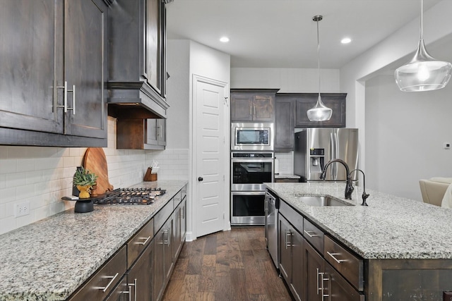 2905 Shires Dr, Mansfield, TX 76084 - kitchen with appliances with stainless steel finishes, a sink, dark wood finished floors, dark brown cabinetry, and recessed lighting