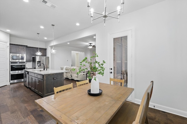 2905 Shires Dr, Mansfield, TX 76084 - dining room featuring recessed lighting, dark wood-style flooring, a chandelier, baseboards, and ceiling fan