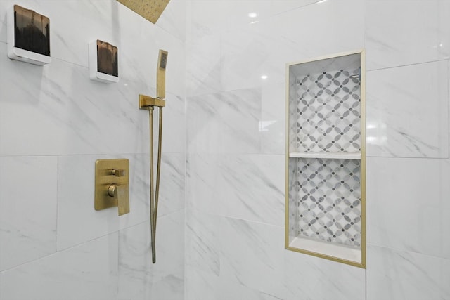 bathroom with tiled shower