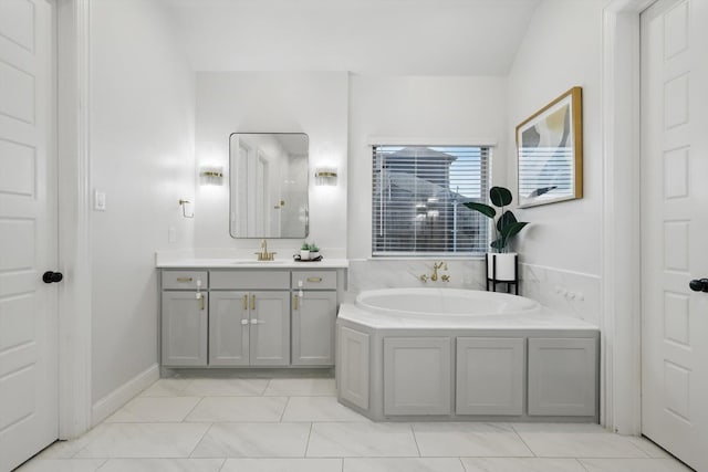 full bathroom with baseboards, a garden tub, and vanity