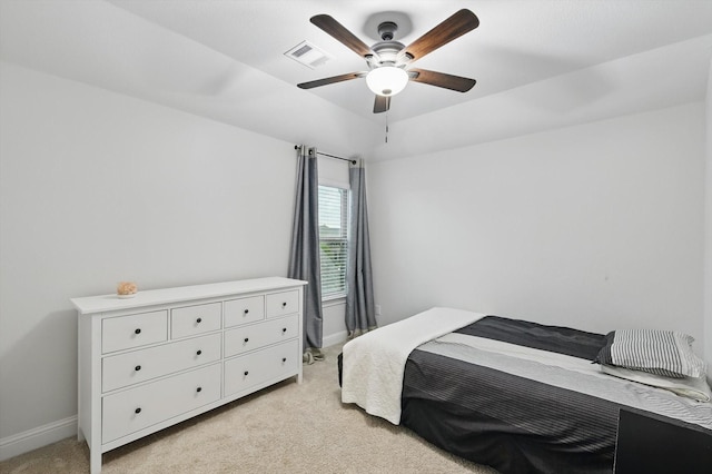 bedroom with baseboards, visible vents, light colored carpet, and ceiling fan