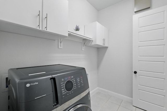 laundry area with cabinet space, independent washer and dryer, baseboards, and light tile patterned flooring