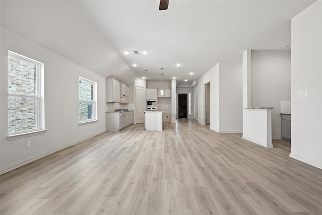 1436 Odette Dr, Arlington, TX 76013 - unfurnished living room with light wood-style floors, a ceiling fan, recessed lighting, and lofted ceiling