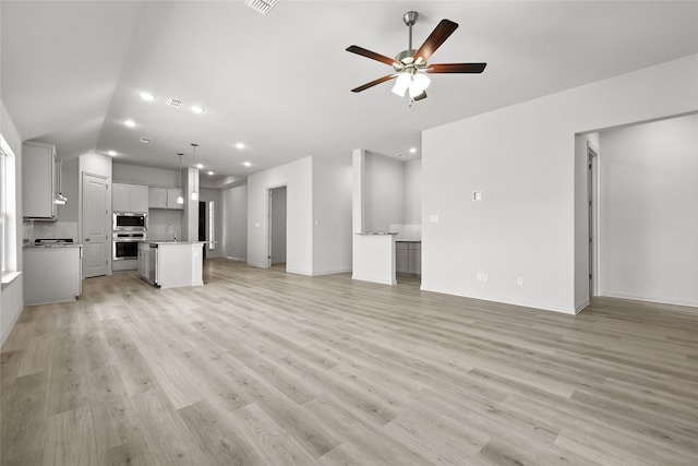 1436 Odette Dr, Arlington, TX 76013 - unfurnished living room featuring ceiling fan, light wood-type flooring, recessed lighting, and vaulted ceiling