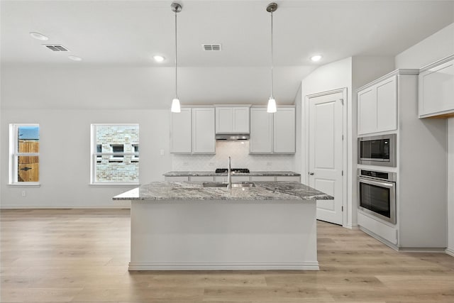 1436 Odette Dr, Arlington, TX 76013 - kitchen featuring stainless steel appliances, light stone counters, backsplash, light wood-style flooring, and white cabinets