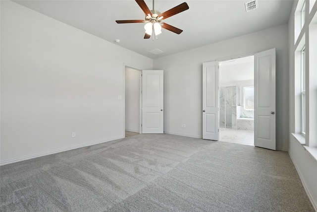 1436 Odette Dr, Arlington, TX 76013 - unfurnished bedroom featuring carpet, connected bathroom, and ceiling fan