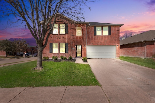 view of front facade with a front lawn, concrete driveway, brick siding, and an attached garage