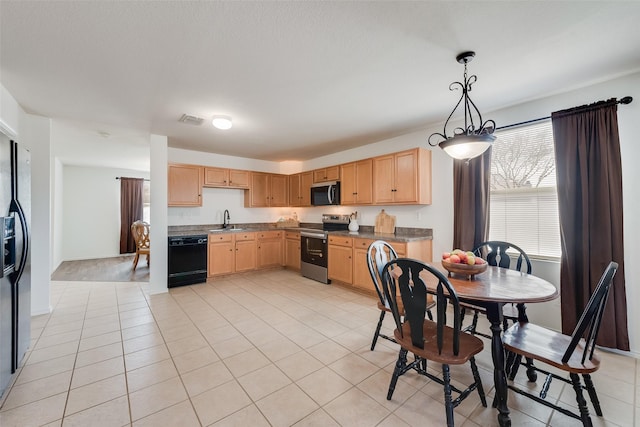 kitchen with a sink, visible vents, black appliances, and light brown cabinets
