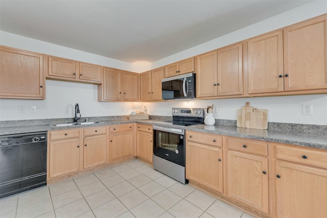 kitchen with a sink, appliances with stainless steel finishes, light tile patterned flooring, and light brown cabinets