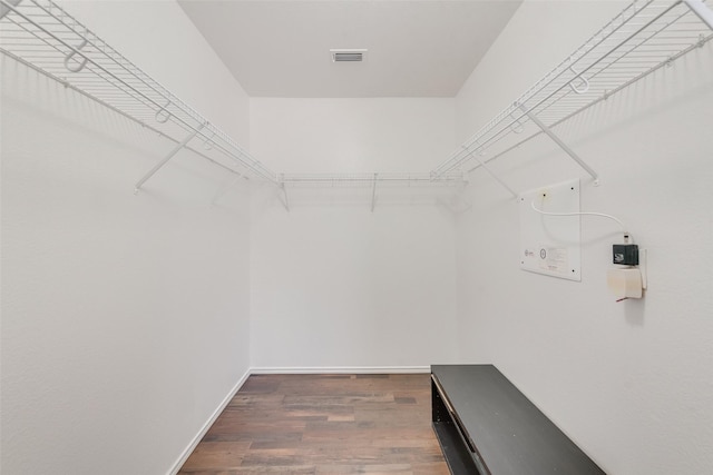 walk in closet featuring visible vents and wood finished floors