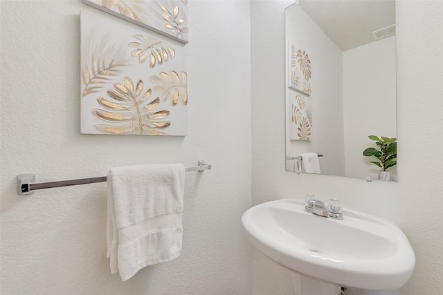 bathroom with visible vents and a sink
