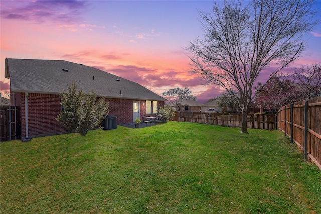 view of yard featuring a fenced backyard and central AC