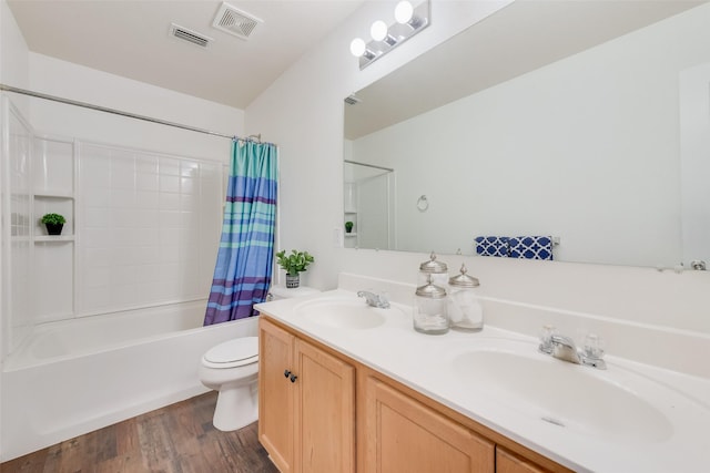 bathroom featuring a sink, toilet, shower / bath combo, and double vanity
