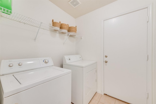 washroom with light tile patterned floors, visible vents, independent washer and dryer, and laundry area