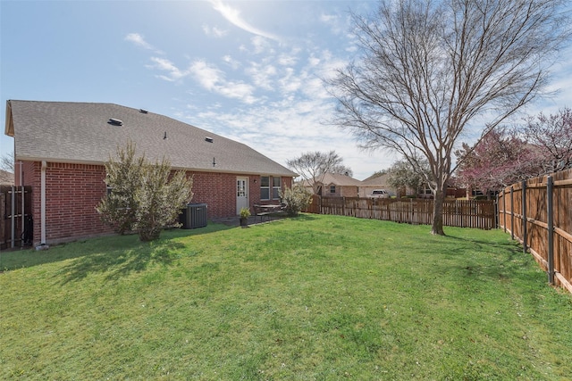 view of yard featuring central AC unit and a fenced backyard