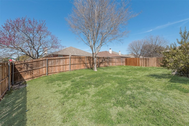 view of yard with a fenced backyard