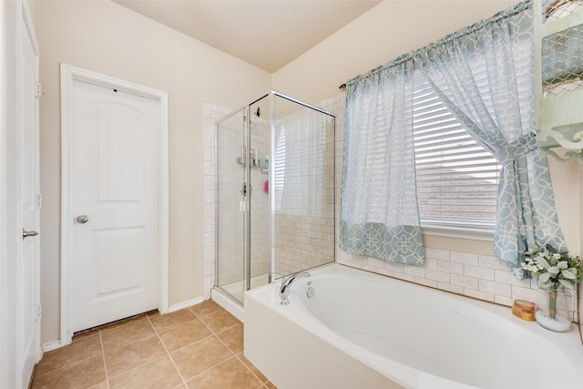 full bath featuring a bath, tile patterned flooring, and a shower stall