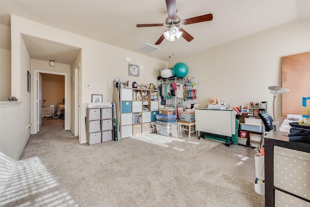 home office with visible vents, ceiling fan, and carpet flooring