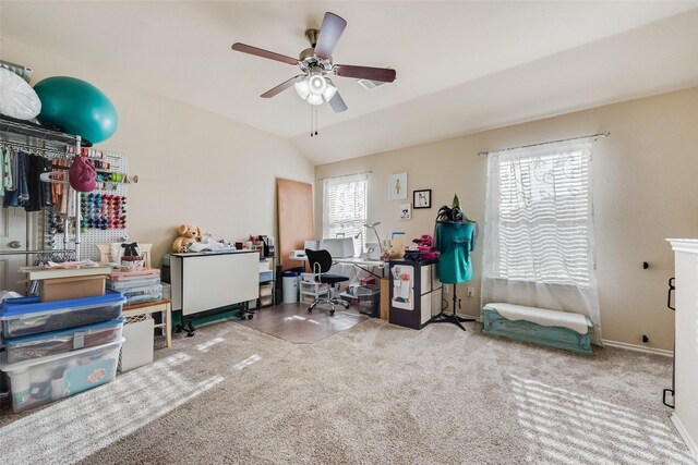 carpeted office space featuring ceiling fan, lofted ceiling, and baseboards