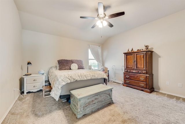 bedroom with lofted ceiling, ceiling fan, baseboards, and light carpet
