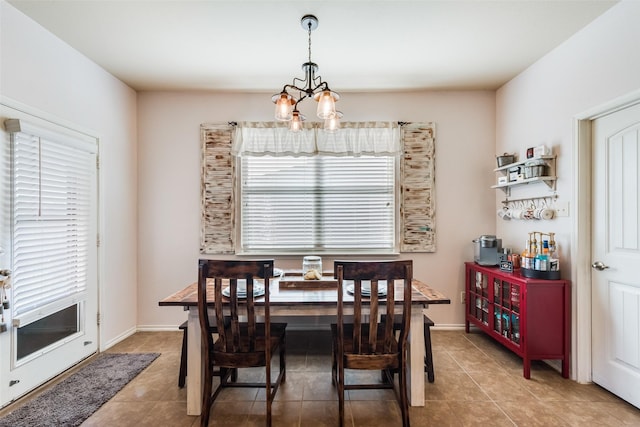 dining area with a notable chandelier and tile patterned flooring