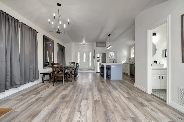 6837 Briar Rd, Azle, TX 76020 - dining area featuring light wood-style floors, a chandelier, and baseboards