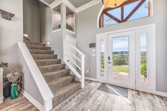 entryway with baseboards, stairway, and wood finished floors