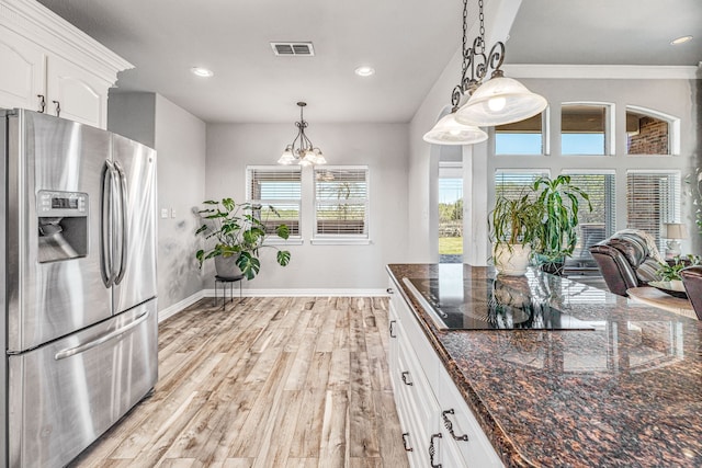 kitchen with white cabinets, stainless steel refrigerator with ice dispenser, light wood-style floors, visible vents, and black electric cooktop