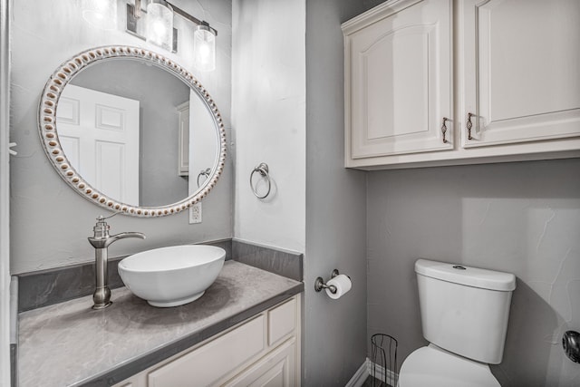 bathroom with toilet and vanity