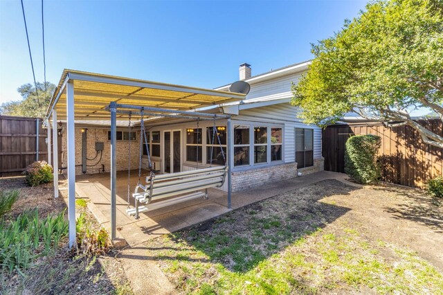 2881 Selma Ln, Farmers Branch, TX 75234 - view of front facade featuring a chimney, a front lawn, and brick siding