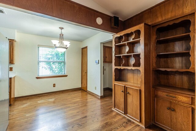 2881 Selma Ln, Farmers Branch, TX 75234 - unfurnished dining area with a textured ceiling, wood finished floors, and a chandelier