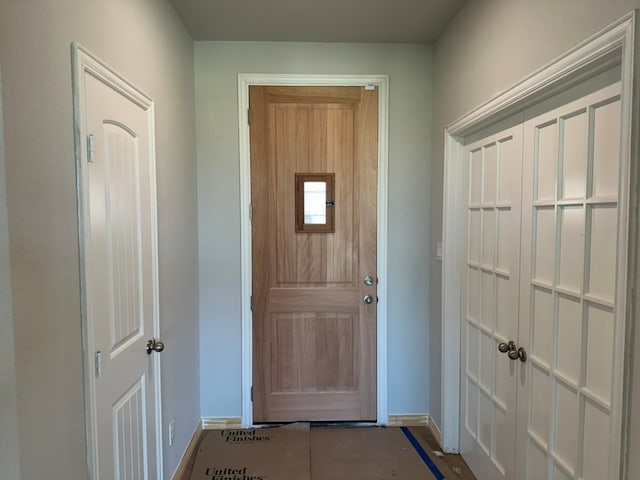 doorway to outside featuring baseboards
