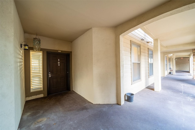 entrance to property featuring stucco siding
