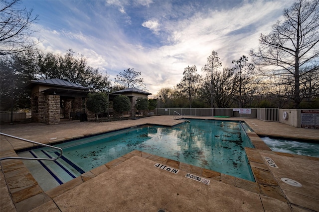 pool featuring fence and a patio area