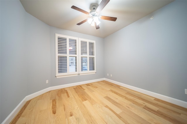 unfurnished room with ceiling fan, baseboards, and wood finished floors