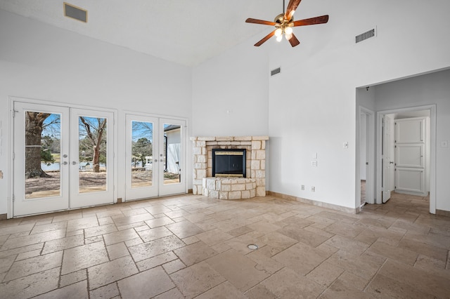 5327 Dusty Rd, Athens, TX 75752 - unfurnished living room featuring high vaulted ceiling, french doors, stone tile flooring, a ceiling fan, and baseboards