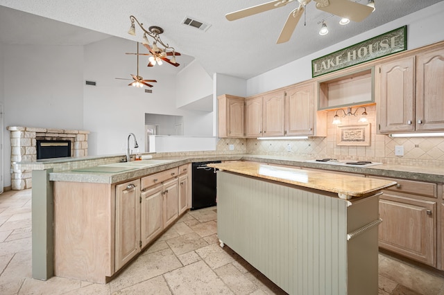 5327 Dusty Rd, Athens, TX 75752 - kitchen featuring light brown cabinets, ceiling fan, dishwasher, stone tile floors, and lofted ceiling
