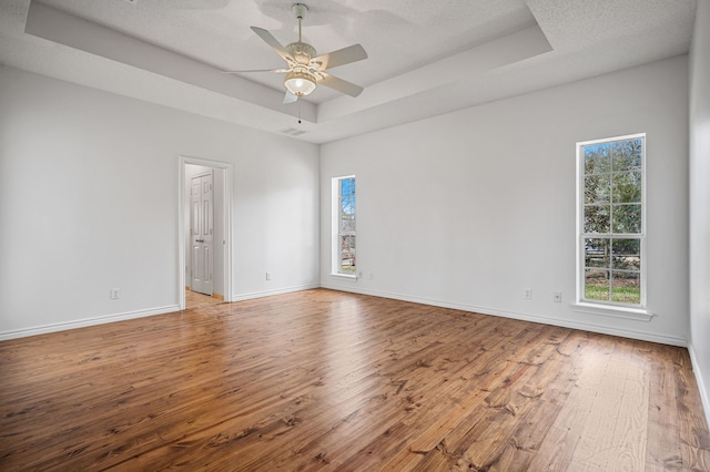 5327 Dusty Rd, Athens, TX 75752 - spare room featuring a raised ceiling, hardwood / wood-style flooring, ceiling fan, and baseboards