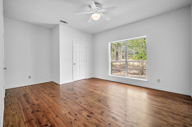 5327 Dusty Rd, Athens, TX 75752 - empty room featuring hardwood / wood-style flooring, a textured ceiling, a ceiling fan, and baseboards