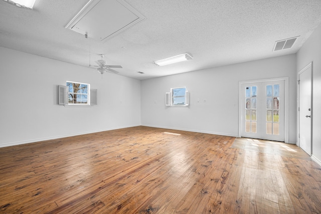 5327 Dusty Rd, Athens, TX 75752 - unfurnished room featuring attic access, a textured ceiling, wood-type flooring, and baseboards